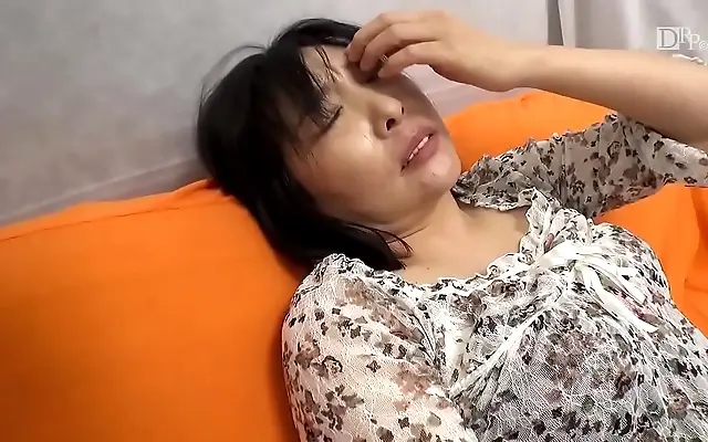 Dim glow reveals daring Japanese milf savoring slow deepthroat bliss
