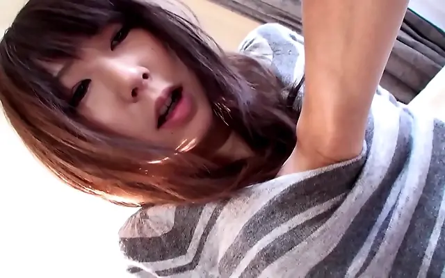 Japanese seductress Reina teases in fishnets and stockings for sexy bedplay