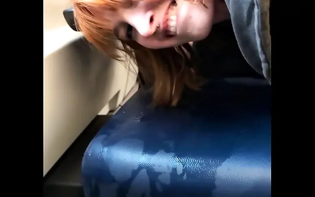 Tiny redhead slut squirts and pees in a busy train during daylight